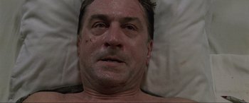 Movie still from “Ronin” (1998), directed by John Frankenheimer – A person laying in a bed; Close Up shot, Overhead angle