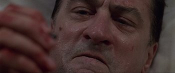 Movie still from “Ronin” (1998), directed by John Frankenheimer – A man's face with sweat coming off of his face; Extreme Close Up shot, Low angle