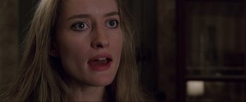 Movie still from “Ronin” (1998), directed by John Frankenheimer – A woman's face in a dark room; Close Up shot, Over the shoulder angle