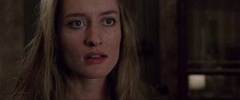 Movie still from “Ronin” (1998), directed by John Frankenheimer – A person with long hair and green eyes; Close Up shot, Over the shoulder angle