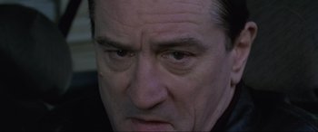 Movie still from “Ronin” (1998), directed by John Frankenheimer – A man's face as he stares at the camera; Close Up shot, Low angle