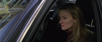 Movie still from “Ronin” (1998), directed by John Frankenheimer – A woman sitting in the passenger seat of a car; Close Up shot, Low angle