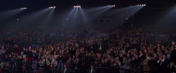 Movie still from “Ronin” (1998), directed by John Frankenheimer – A large crowd of people in a dark room with spotlights; Wide shot, High angle