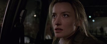 Movie still from “Ronin” (1998), directed by John Frankenheimer – A woman's face in the dark; Close Up shot, Low angle