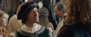 Movie still from “Rosaline” (2022), directed by Karen Maine – A person wearing a hat; Close Up shot, Over the shoulder angle