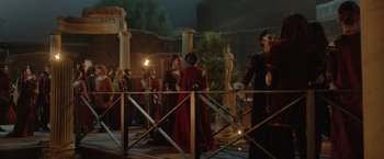 Movie still from “Rosaline” (2022), directed by Karen Maine – A group of people dressed in medieval costumes; Extreme Wide shot, Over the shoulder angle