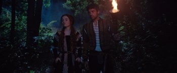 Movie still from “Rosaline” (2022), directed by Karen Maine – A man and a woman standing next to each other; Medium shot, Over the shoulder angle