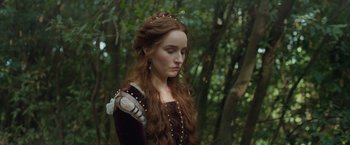 Movie still from “Rosaline” (2022), directed by Karen Maine – A woman with long red curly hair wearing a medieval dress; Close Up shot, Over the shoulder angle
