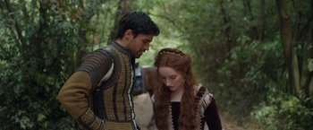 Movie still from “Rosaline” (2022), directed by Karen Maine – A man and a woman standing next to each other; Medium shot, Over the shoulder angle