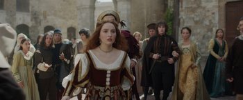 Movie still from “Rosaline” (2022), directed by Karen Maine – A group of people walking down a street; Medium shot, Over the shoulder angle