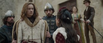 Movie still from “Rosaline” (2022), directed by Karen Maine – Two men and a woman dressed in medieval garb; Medium shot, Over the shoulder angle