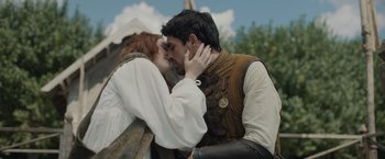 Movie still from “Rosaline” (2022), directed by Karen Maine – A man and a woman are kissing each other outside; Close Up shot, Low angle