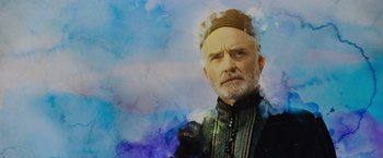 Movie still from “Rosaline” (2022), directed by Karen Maine – An old man with a beard and a hat on his head; Close Up shot, Low angle