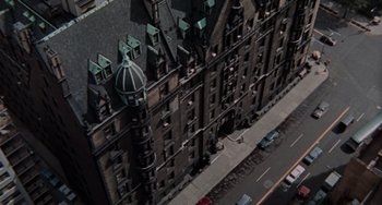 Movie still from “Rosemary's Baby” (1968), directed by Roman Polanski – An aerial view of an old building in the middle of a street; Extreme Wide shot, Overhead angle