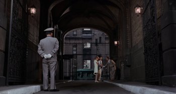 Movie still from “Rosemary's Baby” (1968), directed by Roman Polanski – A group of people standing in an archway; Wide shot, High angle