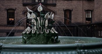 Movie still from “Rosemary's Baby” (1968), directed by Roman Polanski – A fountain with a building in the background; Wide shot, High angle