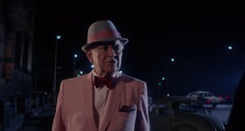Movie still from “Rosemary's Baby” (1968), directed by Roman Polanski – An older man wearing a hat and a suit; Medium shot, Over the shoulder angle