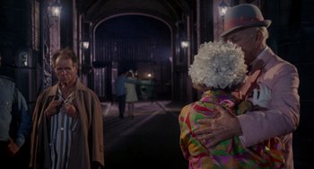 Movie still from “Rosemary's Baby” (1968), directed by Roman Polanski – A man and a woman hugging in a hallway; Medium shot, Over the shoulder angle