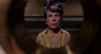 Movie still from “Rosemary's Baby” (1968), directed by Roman Polanski – An older woman wearing a striped shirt and a head scarf; Close Up shot, Low angle