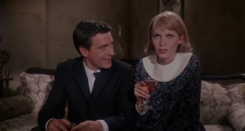 Movie still from “Rosemary's Baby” (1968), directed by Roman Polanski – A man and a woman sitting next to each other holding drinks; Medium shot, High angle