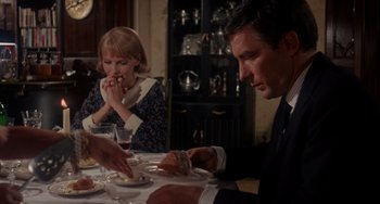 Movie still from “Rosemary's Baby” (1968), directed by Roman Polanski – Three people sitting at a dinner table with food; Medium shot, High angle