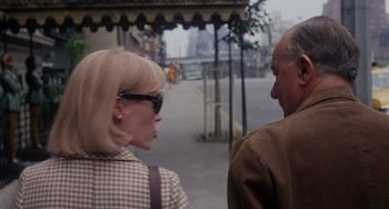 Movie still from “Rosemary's Baby” (1968), directed by Roman Polanski – A woman and an older man walking down a street; Medium shot, Over the shoulder angle