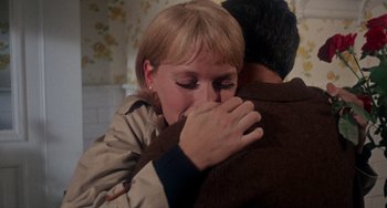 Movie still from “Rosemary's Baby” (1968), directed by Roman Polanski – A woman is hugging a man in a brown jacket; Close Up shot, Over the shoulder angle