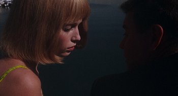 Movie still from “Rosemary's Baby” (1968), directed by Roman Polanski – A woman looking down at a man's face in the dark; Close Up shot, High angle