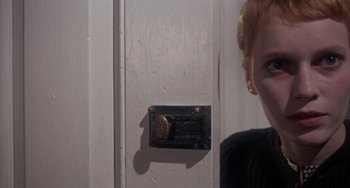 Movie still from “Rosemary's Baby” (1968), directed by Roman Polanski – A woman standing in front of a door with a lock; Close Up shot, Over the shoulder angle