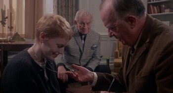 Movie still from “Rosemary's Baby” (1968), directed by Roman Polanski – A young boy being examined by an older gentleman; Medium shot, High angle