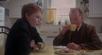 Movie still from “Rosemary's Baby” (1968), directed by Roman Polanski – Two people sitting at a table drinking coffee; Medium shot, Over the shoulder angle