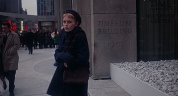 Movie still from “Rosemary's Baby” (1968), directed by Roman Polanski – A woman in a beret is walking down the street; Wide shot, Low angle