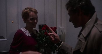 Movie still from “Rosemary's Baby” (1968), directed by Roman Polanski – A man and a woman holding a bouquet of roses; Medium shot, Over the shoulder angle