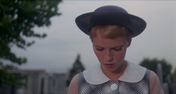 Movie still from “Rosemary's Baby” (1968), directed by Roman Polanski – A woman wearing a black hat and a white collar; Close Up shot, Low angle