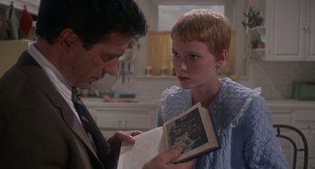 Movie still from “Rosemary's Baby” (1968), directed by Roman Polanski – A man and a woman are looking at a book; Close Up shot, Over the shoulder angle