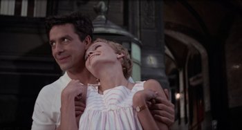 Movie still from “Rosemary's Baby” (1968), directed by Roman Polanski – A man and a woman standing next to each other in front of a building; Medium shot, Low angle
