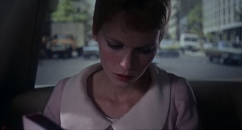 Movie still from “Rosemary's Baby” (1968), directed by Roman Polanski – A person with short hair looking down; Close Up shot, Over the shoulder angle