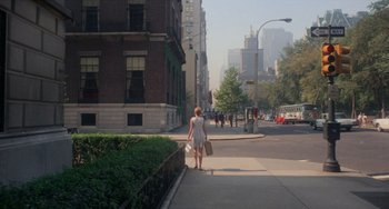 Movie still from “Rosemary's Baby” (1968), directed by Roman Polanski – A woman walking down the street holding a shopping bag; Extreme Wide shot, High angle