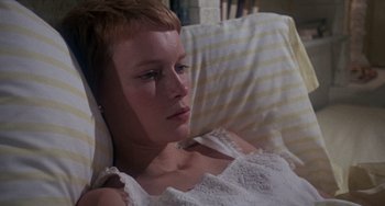 Movie still from “Rosemary's Baby” (1968), directed by Roman Polanski – A woman in a white dress laying in a bed; Close Up shot, High angle