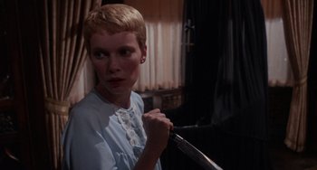 Movie still from “Rosemary's Baby” (1968), directed by Roman Polanski – A woman holding a knife in a room; Close Up shot, Over the shoulder angle