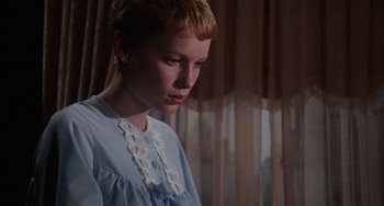 Movie still from “Rosemary's Baby” (1968), directed by Roman Polanski – A young girl in a blue dress looking down; Close Up shot, Low angle