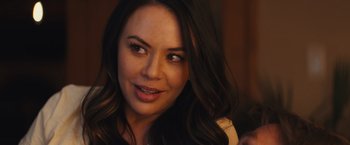 Movie still from “Run & Gun” (2022), directed by Christopher Borrelli – A person with long hair; Close Up shot, Over the shoulder angle