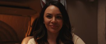 Movie still from “Run & Gun” (2022), directed by Christopher Borrelli – A person with long black hair; Close Up shot, Over the shoulder angle