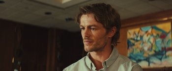 Movie still from “Run & Gun” (2022), directed by Christopher Borrelli – A person with long hair; Close Up shot, Low angle