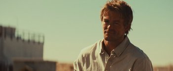 Movie still from “Run & Gun” (2022), directed by Christopher Borrelli – A person wearing a white shirt; Close Up shot, Over the shoulder angle