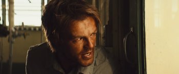 Movie still from “Run & Gun” (2022), directed by Christopher Borrelli – A person with long hair; Close Up shot, Low angle