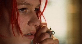 Movie still from “Run Lola Run” (1998), directed by Tom Tykwer – A person holding a cell phone to their ear; Close Up shot, High angle