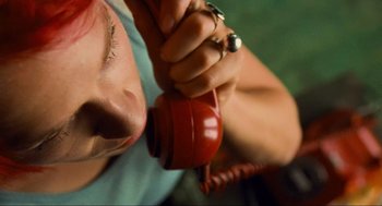 Movie still from “Run Lola Run” (1998), directed by Tom Tykwer – A person holding a tea pot in their hand; Extreme Close Up shot, Overhead angle