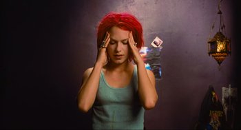 Movie still from “Run Lola Run” (1998), directed by Tom Tykwer – A woman with red hair holding her hands to her head; Close Up shot, High angle