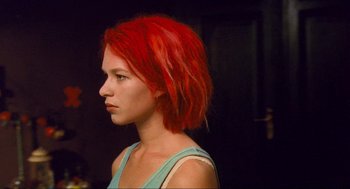 Movie still from “Run Lola Run” (1998), directed by Tom Tykwer – A woman with red hair is looking to the side; Close Up shot, Over the shoulder angle